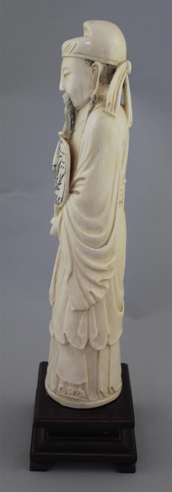 A large Chinese ivory figure of a scholar, early 20th century, 26.5cm, wood stand